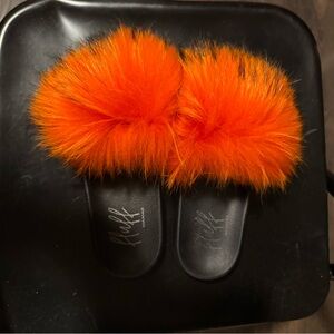 Fluffy orange raccoon slides, pre owned and in excellent condition